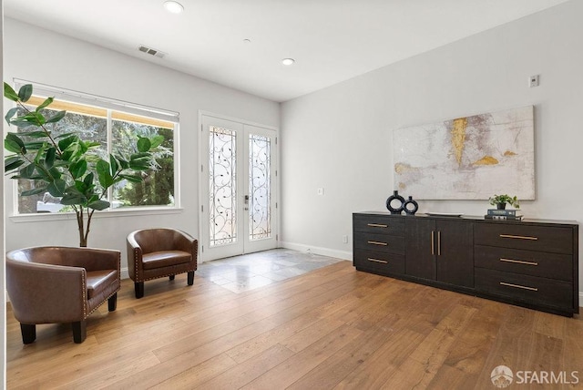sitting room with recessed lighting, baseboards, french doors, and light wood finished floors
