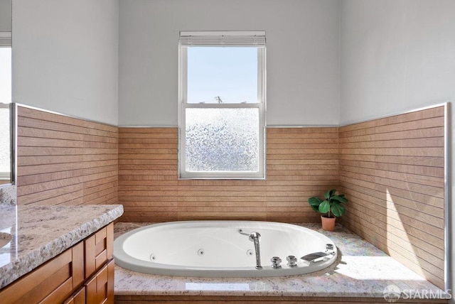 bathroom featuring a whirlpool tub and wainscoting