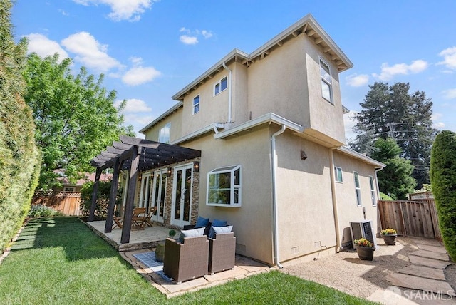 rear view of house with a pergola, fence, a patio area, and stucco siding