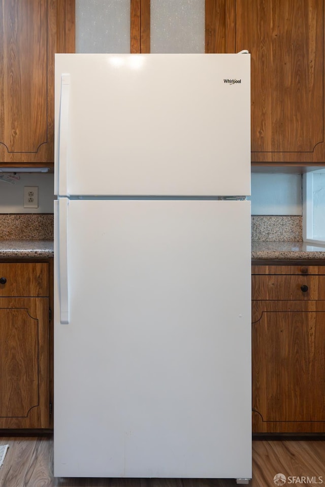 kitchen with white fridge and light hardwood / wood-style flooring