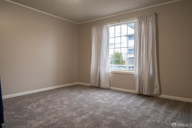 carpeted empty room featuring ornamental molding and a textured ceiling