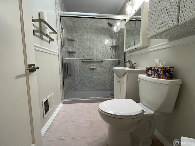 bathroom featuring walk in shower, vanity, toilet, and tile patterned flooring