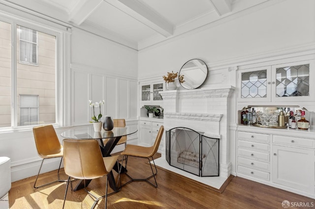 1265 Union St, San Francisco, CA 94109 - dining room featuring beam ceiling, dark wood-type flooring, a decorative wall, a fireplace, and ornamental molding