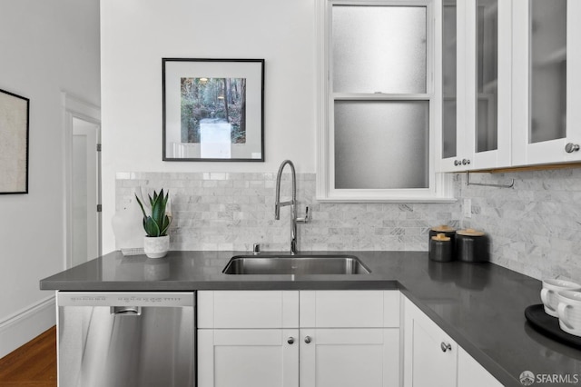 1265 Union St, San Francisco, CA 94109 - kitchen with stainless steel dishwasher, a sink, dark countertops, and decorative backsplash