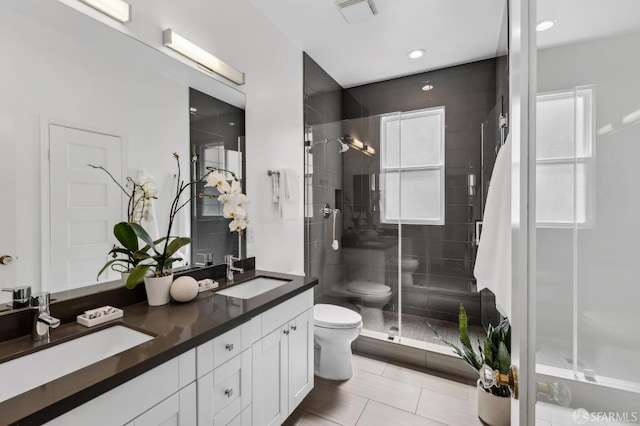 1265 Union St, San Francisco, CA 94109 - full bathroom featuring toilet, a shower stall, double vanity, tile patterned flooring, and recessed lighting