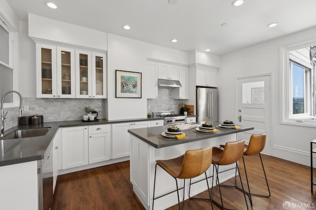 1265 Union St, San Francisco, CA 94109 - kitchen with a sink, stainless steel appliances, dark countertops, white cabinets, and recessed lighting