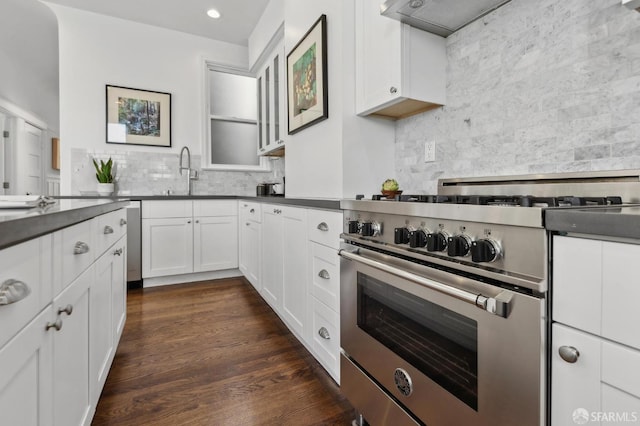 1265 Union St, San Francisco, CA 94109 - kitchen with high end range, tasteful backsplash, a sink, dark countertops, and white cabinetry