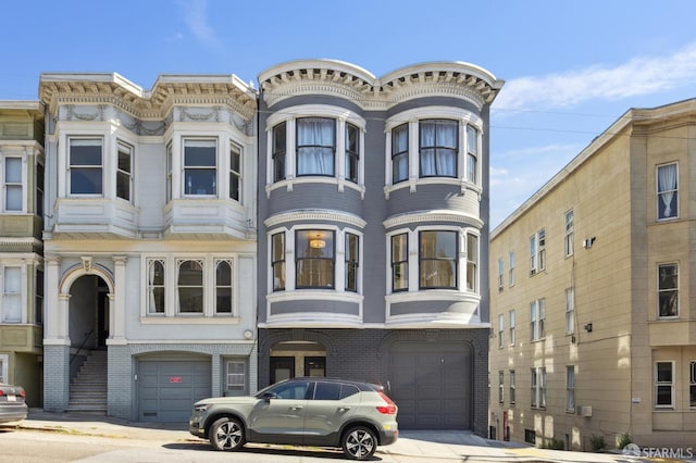 1265 Union St, San Francisco, CA 94109 - view of front facade featuring a garage, brick siding, and driveway