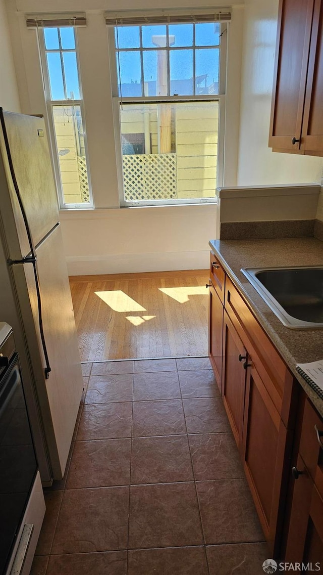 kitchen featuring sink, dark hardwood / wood-style floors, white refrigerator, and range