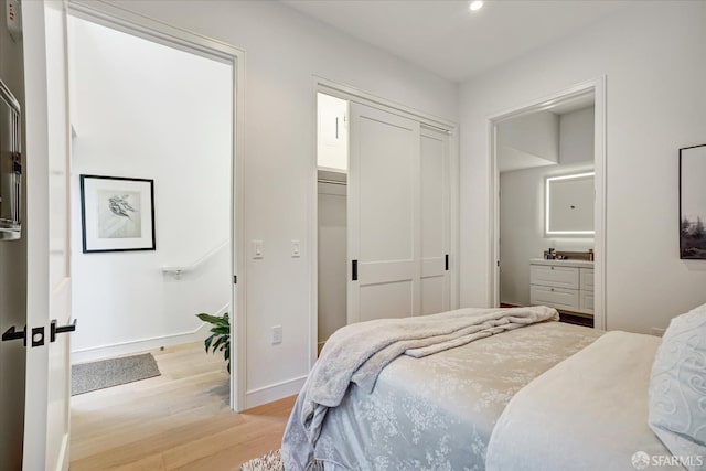 150 Eureka St, San Francisco, CA 94114 - bedroom with light wood finished floors, recessed lighting, baseboards, ensuite bathroom, and a closet