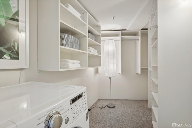 washroom with washer and dryer and light carpet