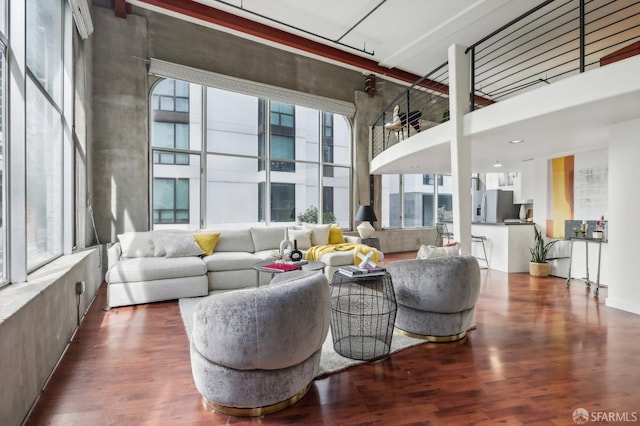 living room featuring hardwood / wood-style floors and a towering ceiling