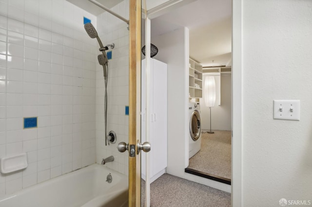 bathroom with washer / clothes dryer and tiled shower / bath