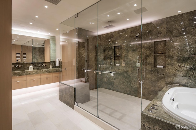 bathroom with vanity, tile walls, and shower with separate bathtub