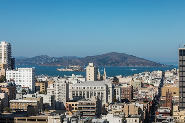 property's view of city with a water and mountain view