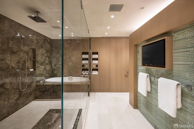 bathroom featuring shower with separate bathtub and tile walls