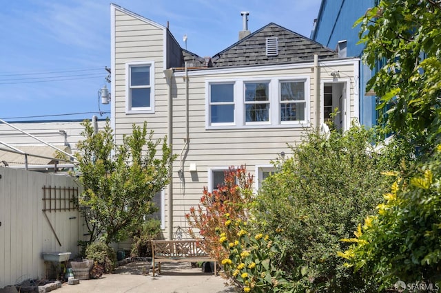 3031 20th St, San Francisco, CA 94110 - view of side of property featuring roof with shingles and a patio