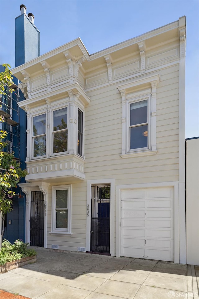 3031 20th St, San Francisco, CA 94110 - view of front of house featuring an attached garage, concrete driveway, and a chimney