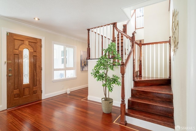 entrance foyer featuring crown molding, stairs, baseboards, and wood finished floors