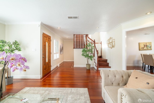 foyer entrance with wood finished floors, visible vents, baseboards, stairs, and crown molding