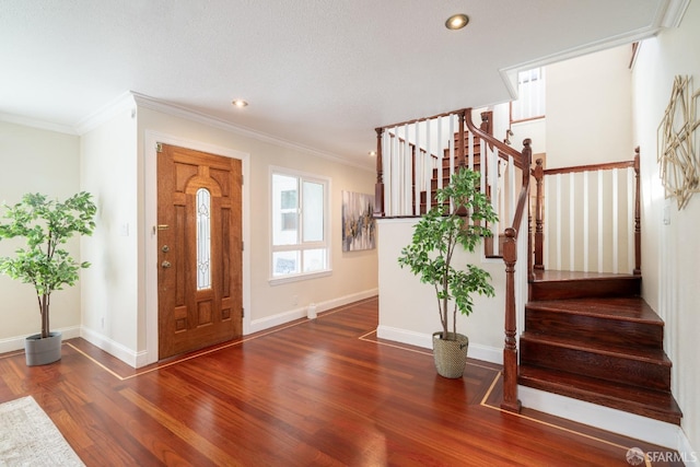 entrance foyer with baseboards, wood finished floors, and crown molding