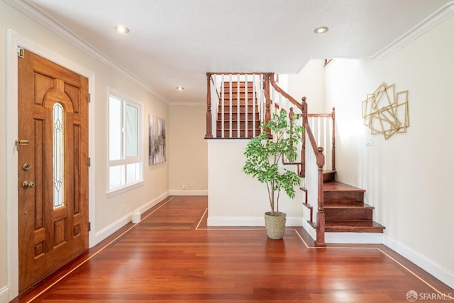 entryway with stairs, ornamental molding, and wood finished floors