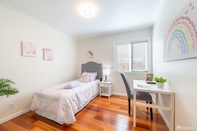 bedroom with wood finished floors and baseboards