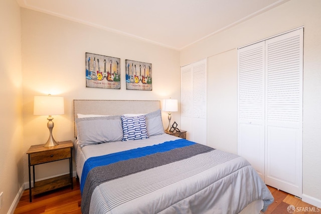 bedroom featuring baseboards and wood finished floors