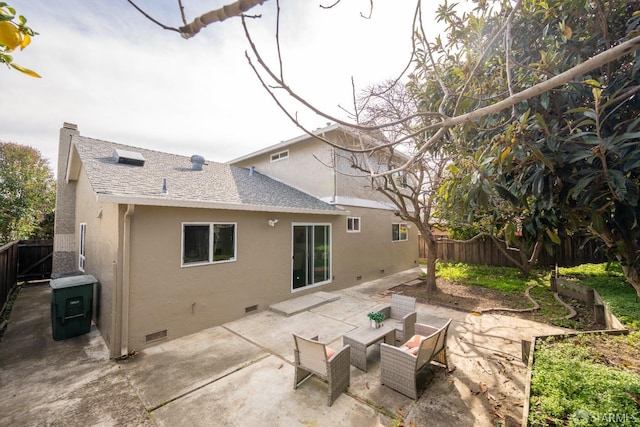 rear view of house featuring roof with shingles, a patio, stucco siding, crawl space, and a fenced backyard