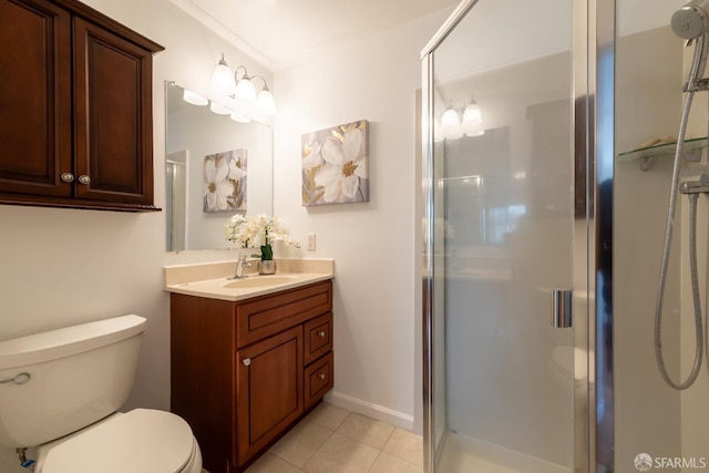 bathroom featuring toilet, a shower stall, vanity, and tile patterned floors