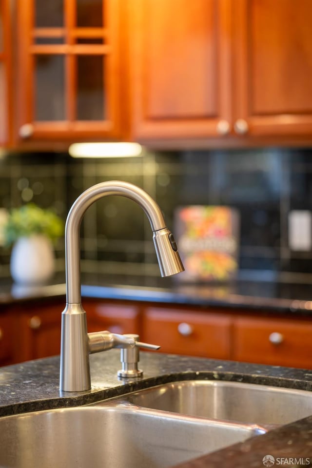 room details featuring dark countertops and a sink