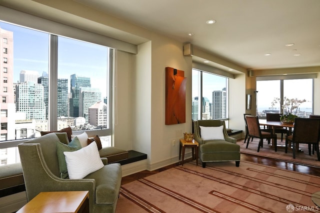 765 Market St Unit 22D, San Francisco, CA 94103 - living area featuring a skyline view, plenty of natural light, wood finished floors, and recessed lighting