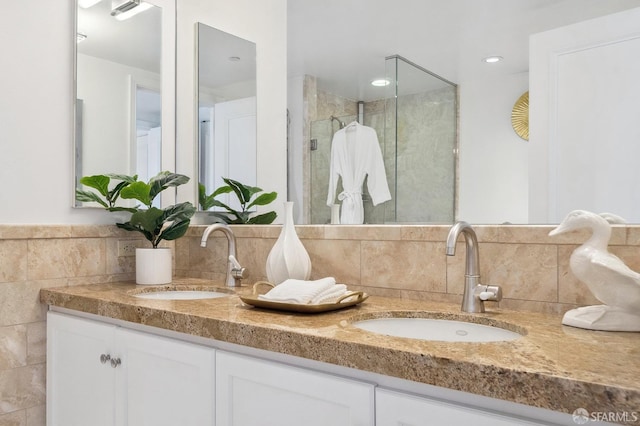 765 Market St Unit 22D, San Francisco, CA 94103 - bathroom featuring double vanity, a shower stall, and tile walls