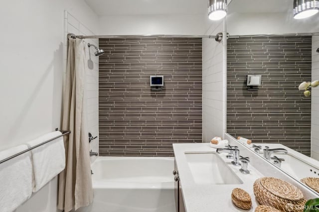 bathroom featuring vanity and shower / bathtub combination with curtain