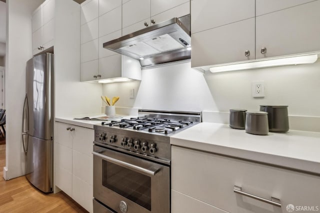 kitchen featuring white cabinets, stainless steel appliances, light wood-type flooring, and exhaust hood