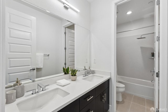 full bathroom featuring tile patterned floors, toilet, vanity, and shower / washtub combination