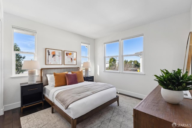 bedroom featuring hardwood / wood-style flooring and multiple windows