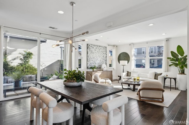 dining area featuring a chandelier and dark hardwood / wood-style flooring