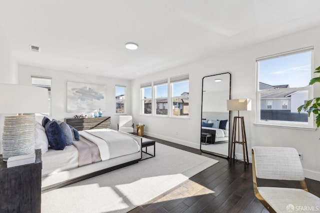 bedroom with dark hardwood / wood-style flooring