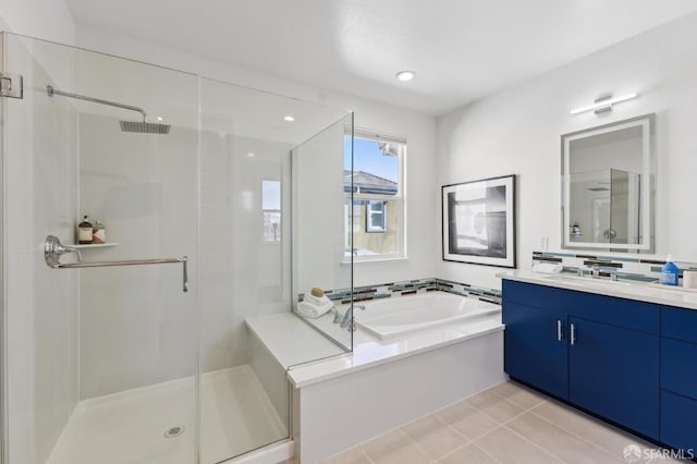 bathroom with independent shower and bath, tile patterned flooring, and vanity