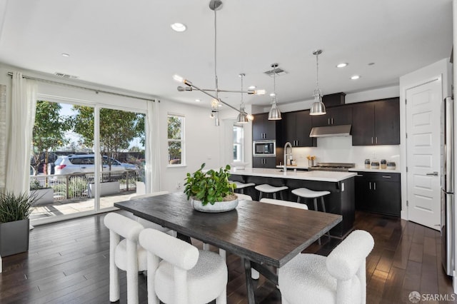 dining space featuring sink and dark hardwood / wood-style floors