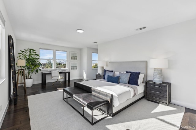 bedroom with dark hardwood / wood-style floors