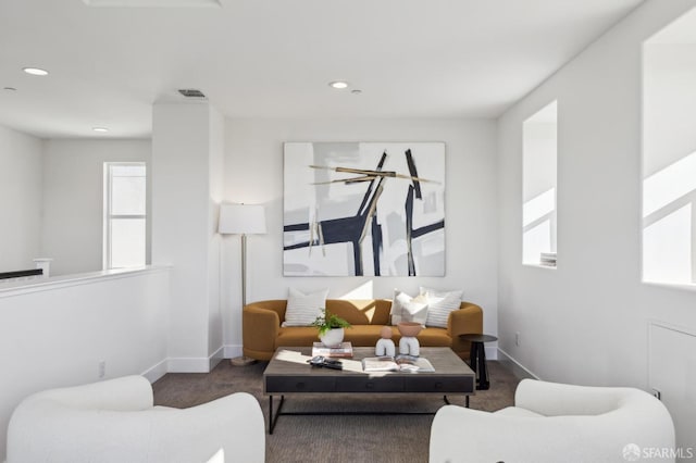 carpeted living room featuring plenty of natural light