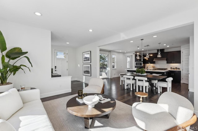 living room with sink and dark wood-type flooring