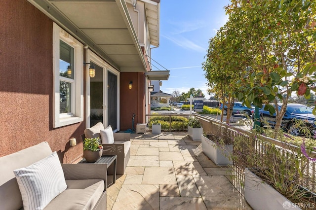 view of patio / terrace with a balcony and outdoor lounge area