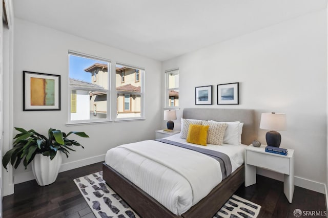 bedroom with dark hardwood / wood-style flooring