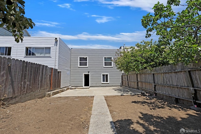 1187 Hollister St, San Francisco, CA 94124 - rear view of house featuring a patio area and a fenced backyard