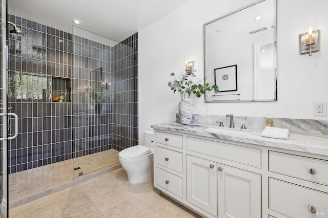 bathroom with toilet, vanity, and an enclosed shower