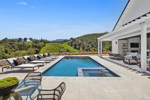 view of pool with a pergola, a mountain view, outdoor lounge area, and a patio