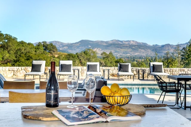 view of swimming pool featuring a mountain view and a patio